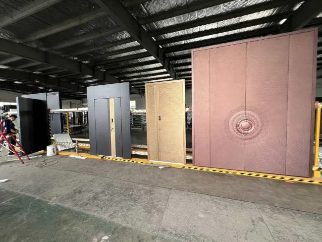 Finished security door designs displayed for inspection in the KEST Door workshop.